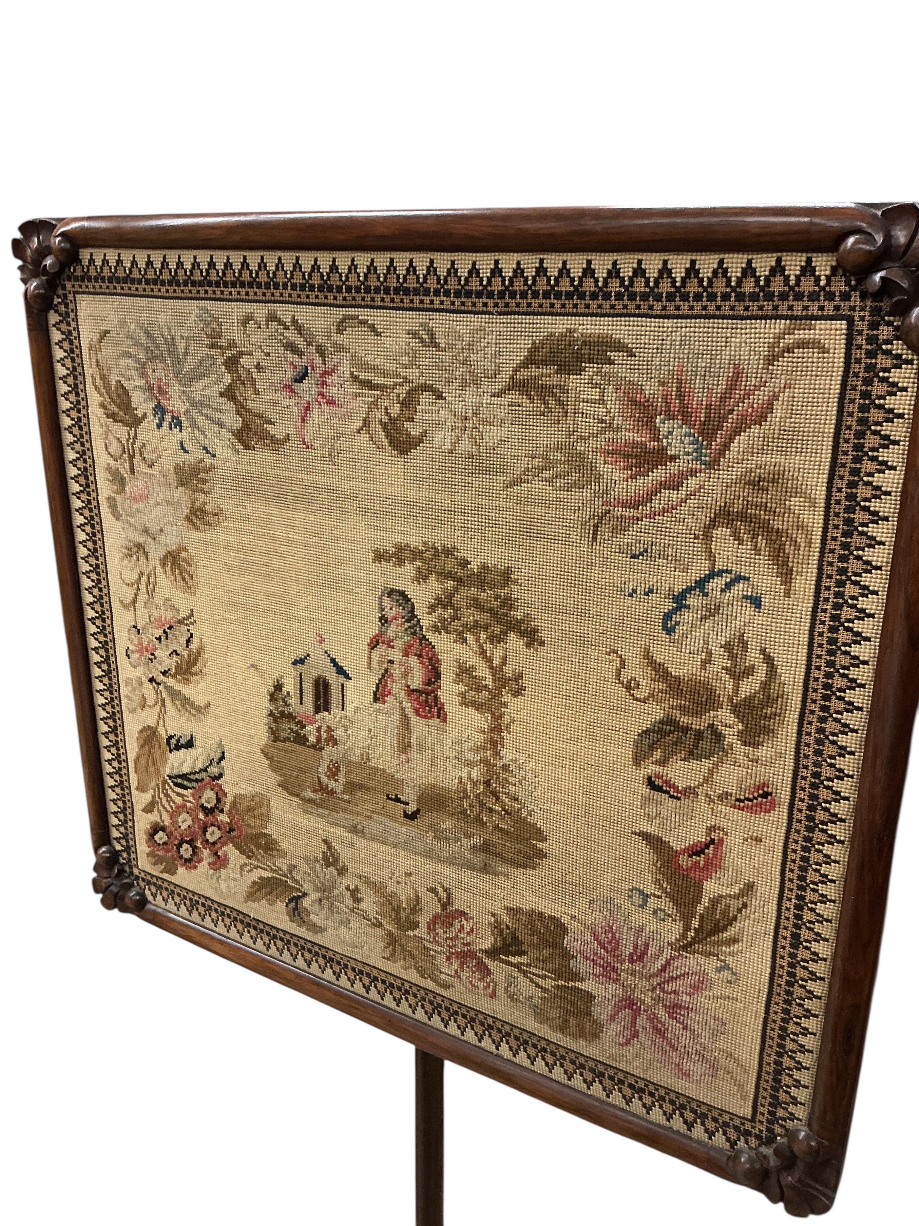 An early Victorian rosewood pole screen with polychrome tapestry banner, height 155cm